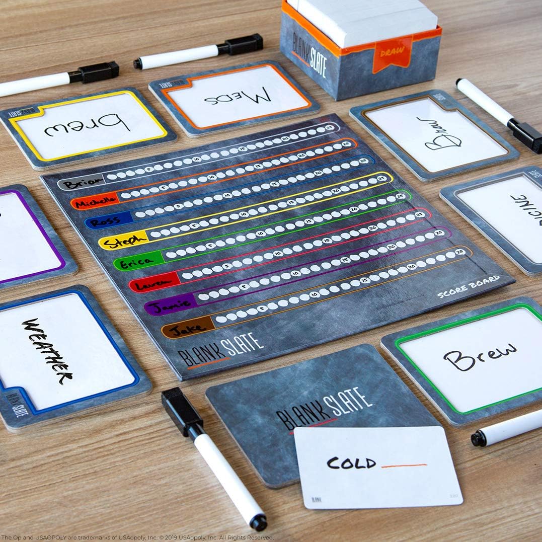 Blank slate game components on a wooden surface with markers.
