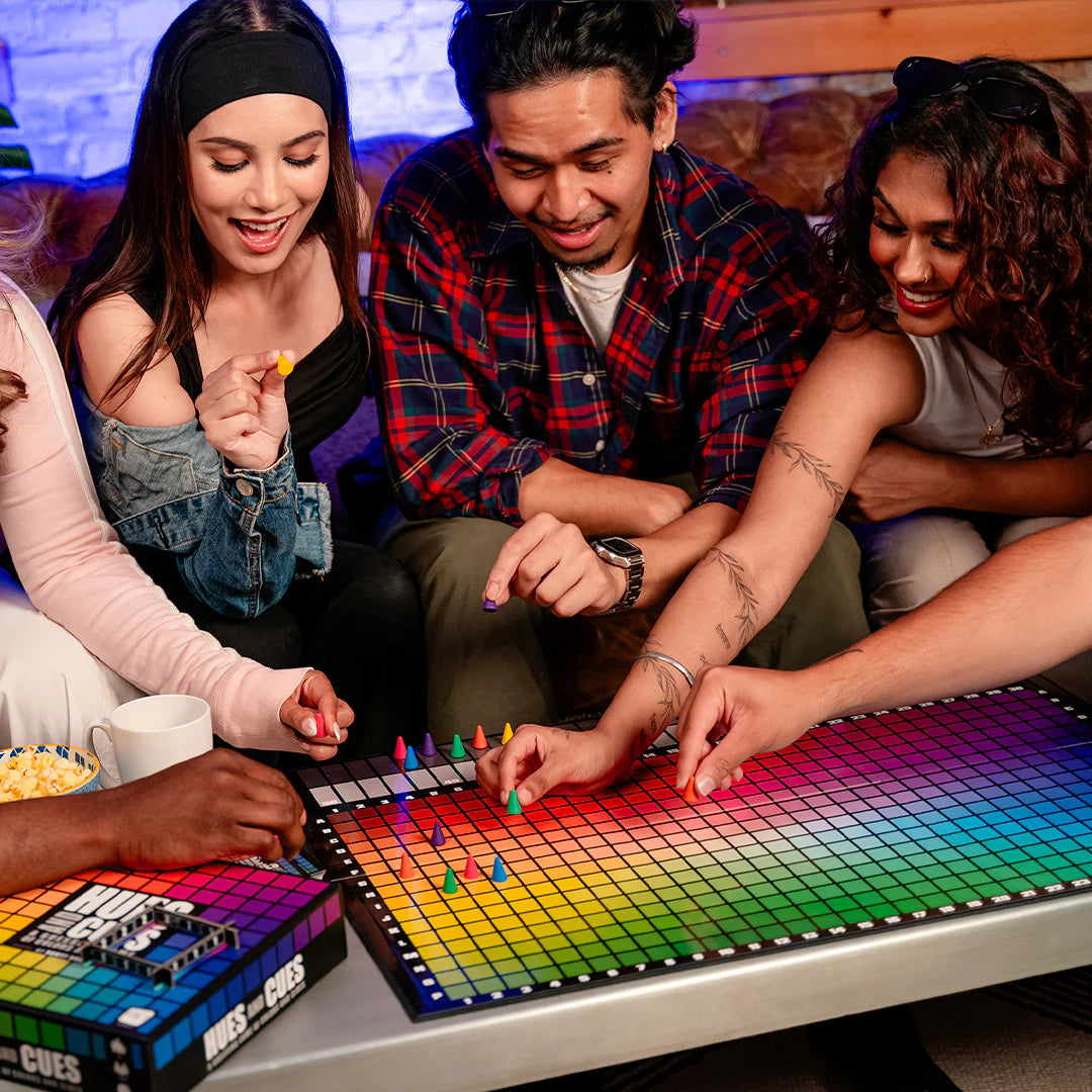 Group of people playing Hues and Cues board game together.