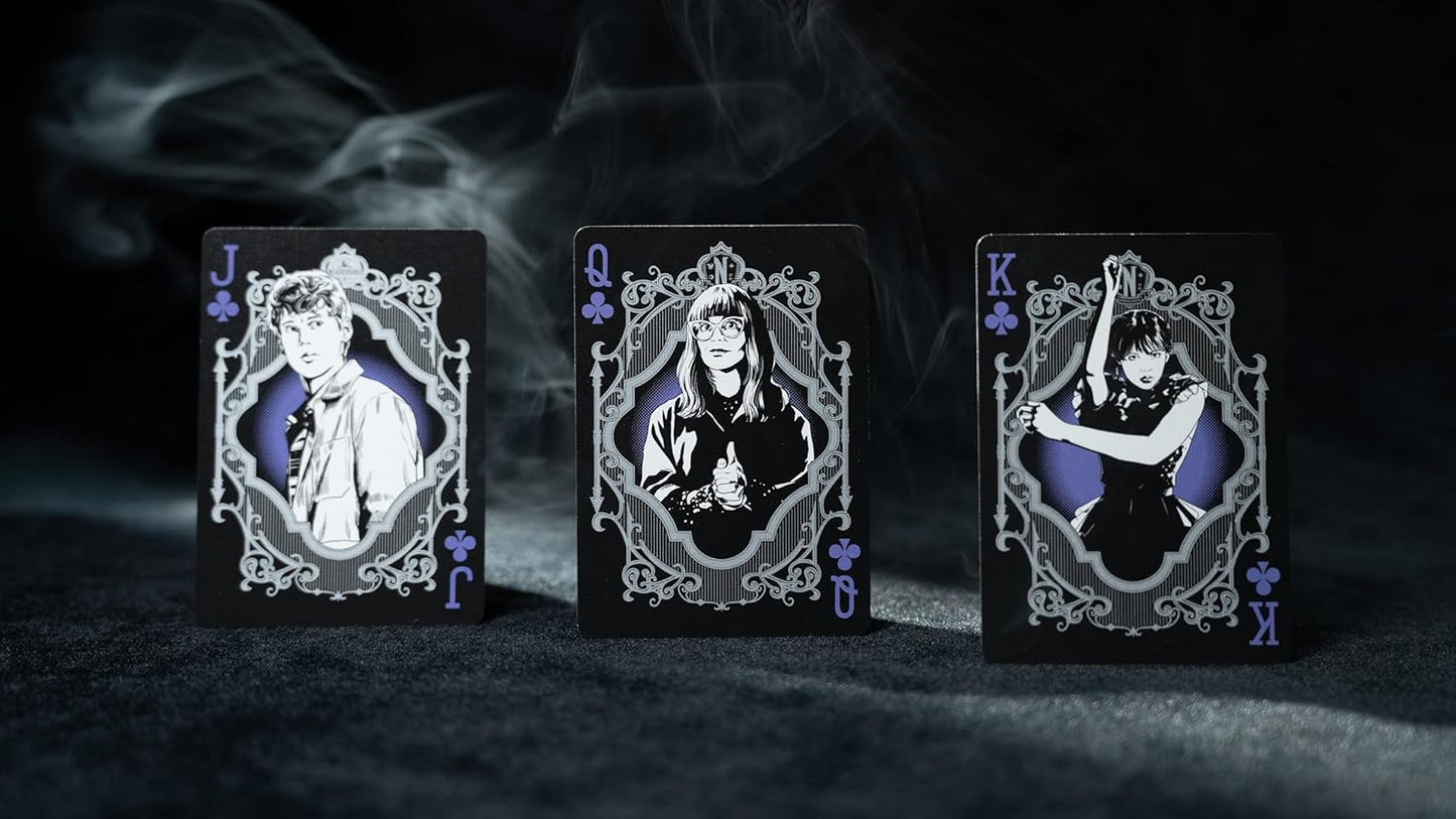 Three playing card figures with intricate designs on a dark background