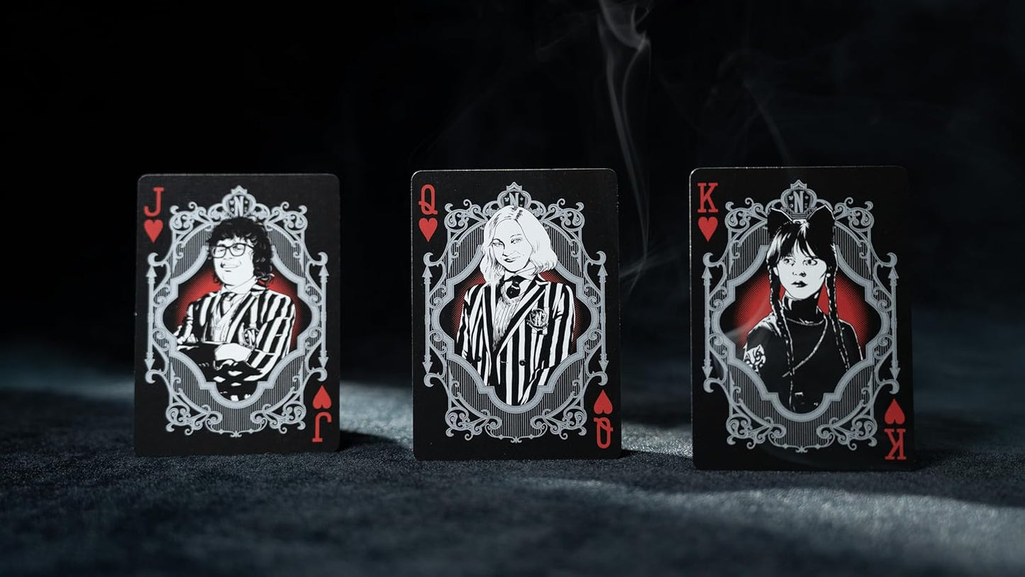 Three playing cards with character illustrations on a dark background
