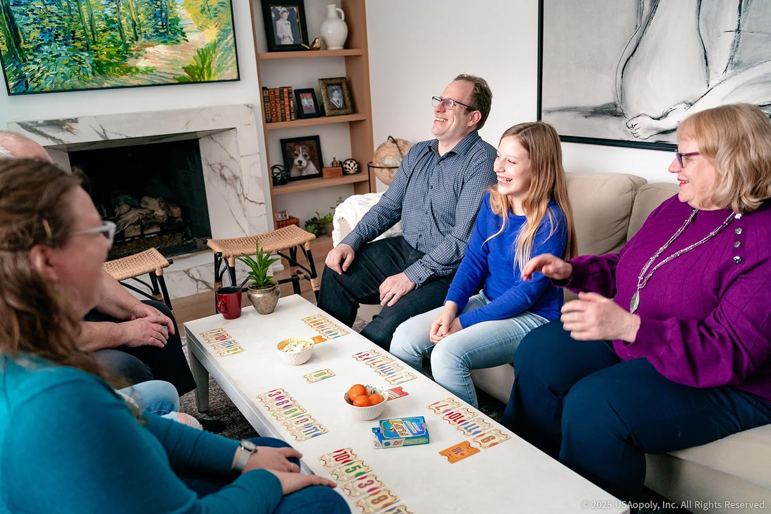 Family playing Flip 7 in a cosy living room with a fireplace and artwork.