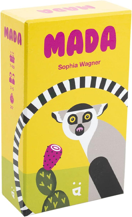 The image shows the packaging of the board game 'Mada'. The box is predominantly yellow with an illustration of a lemur and a cactus.