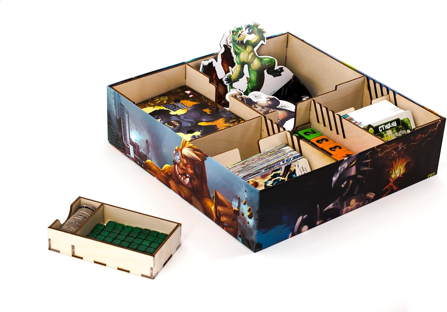 Board game box with compartments containing game pieces and cards on a white background