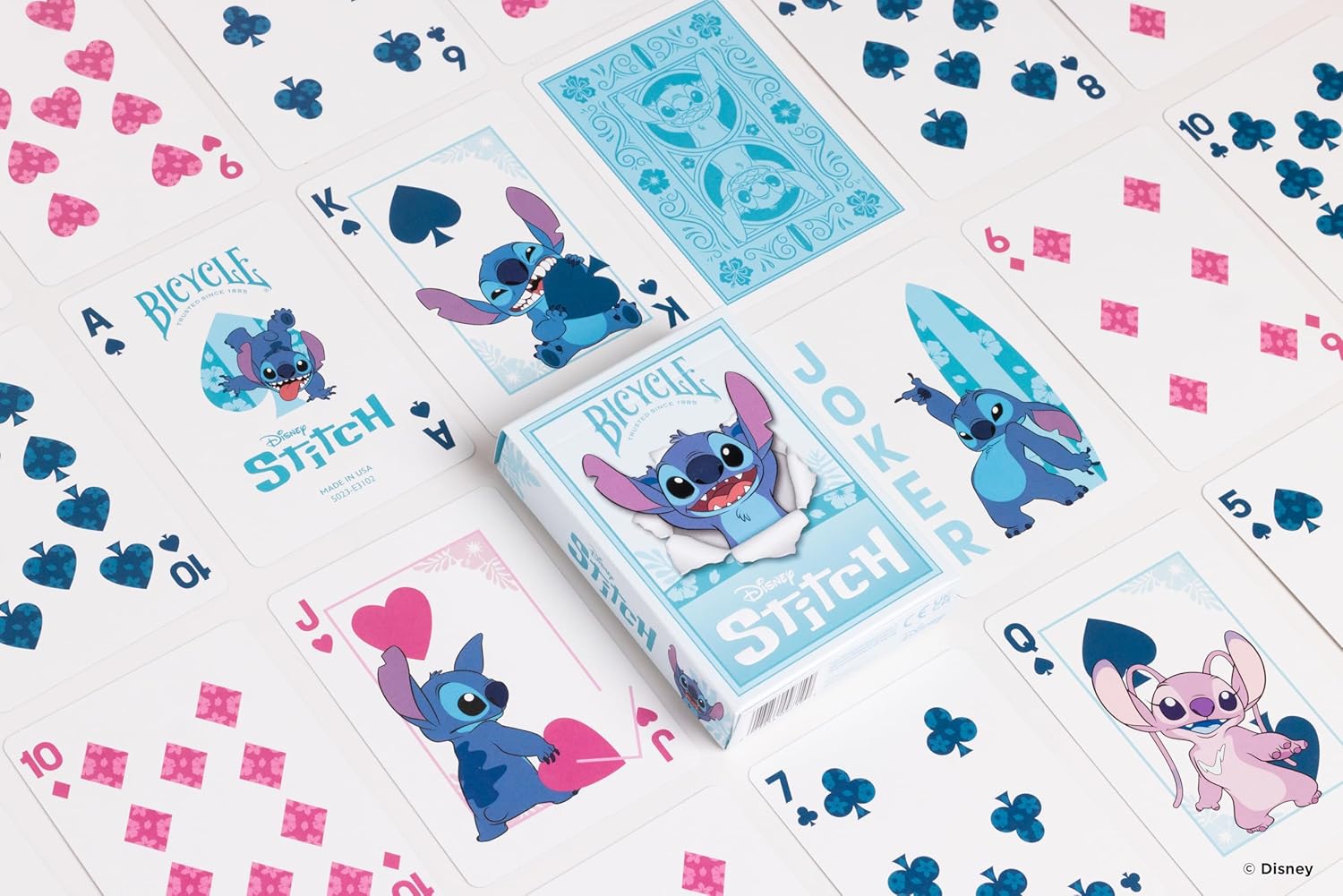 Playing cards featuring Stitch from Disney on a decorative surface with hearts and flowers.