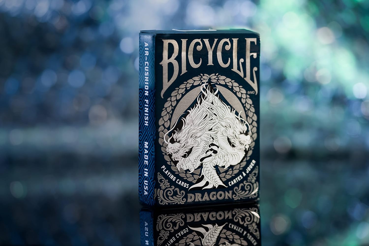 Bicycle Dragon playing card box with a blue and gold design on a blurred background