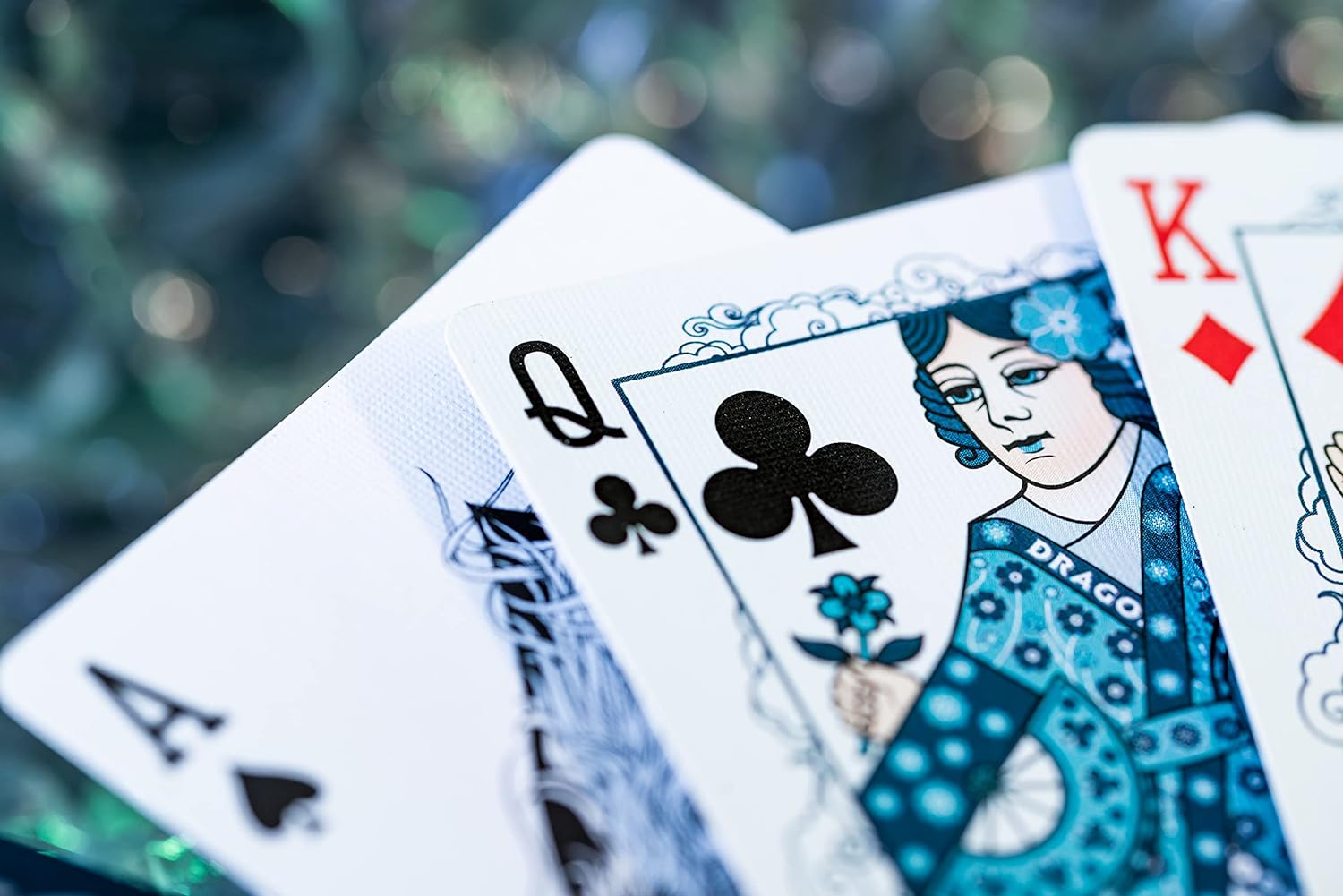 Playing cards with Queen of Clubs and King of Hearts on a blurred background
