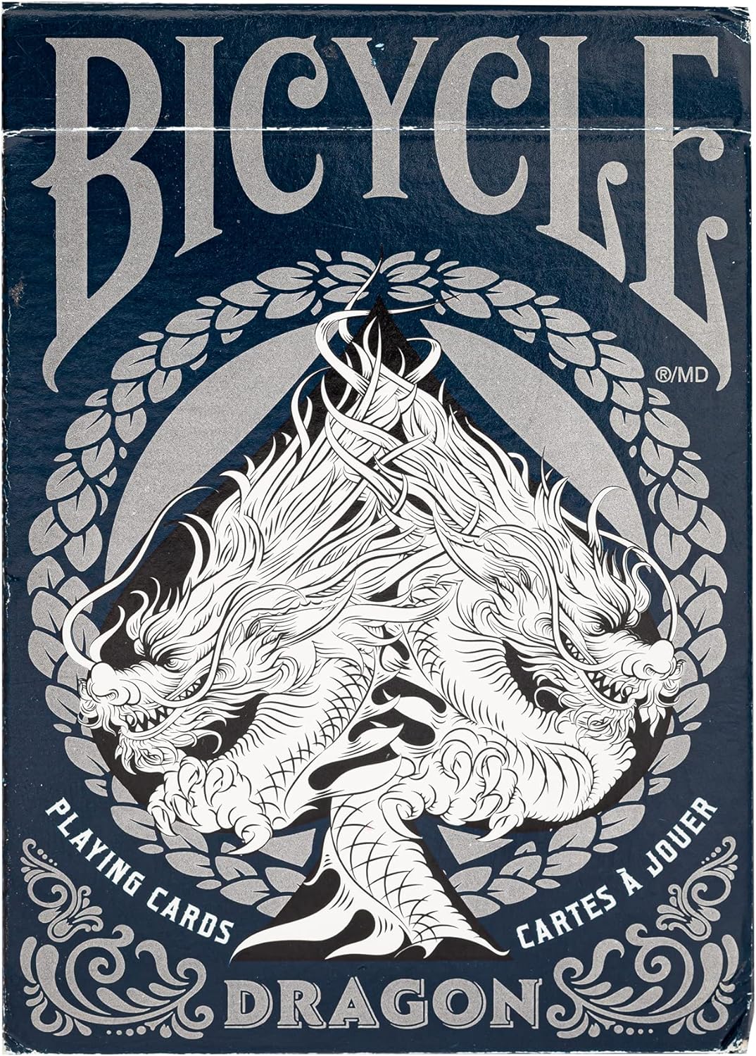 packaging of Bicycle Dragon Playing Cards featuring a detailed, monochrome illustration of a dragon surrounded by ornate designs, with the Bicycle brand prominently shown.