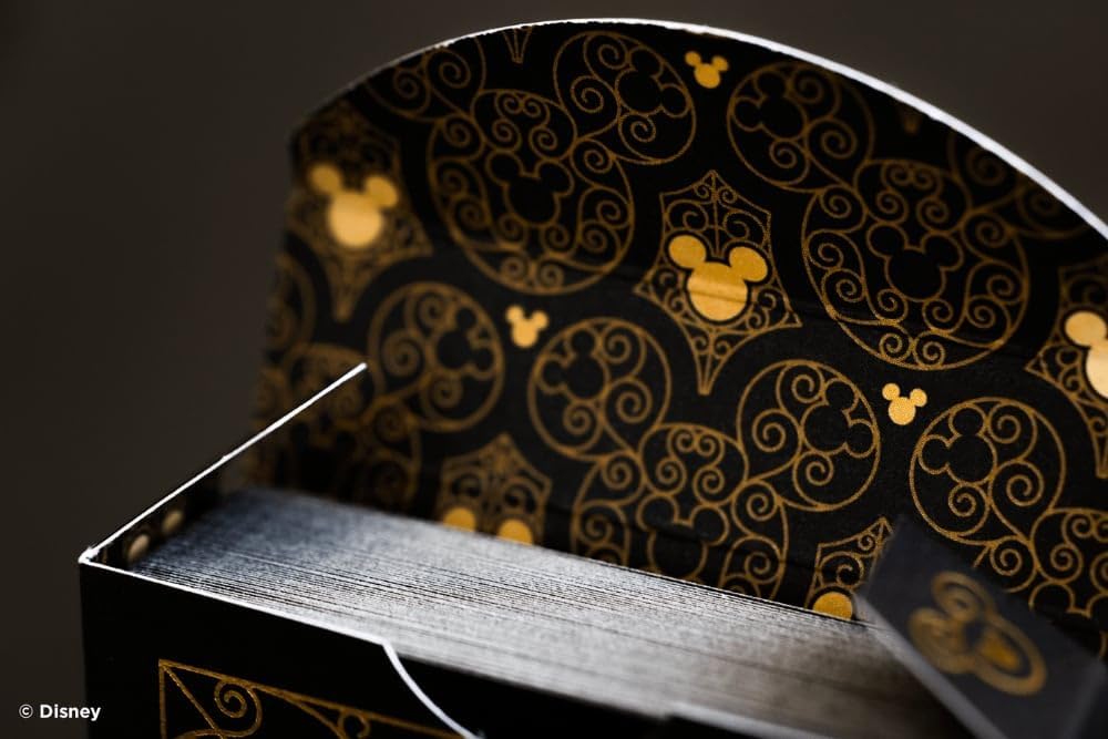 Decorative box with gold Mickey Mouse patterns on a dark background