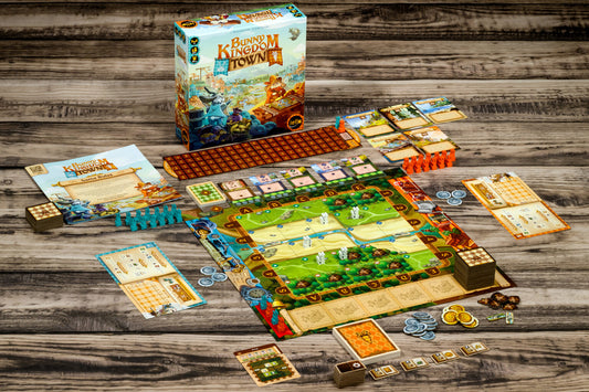 Board game set up on a wooden table with Bunny Kingdom box.