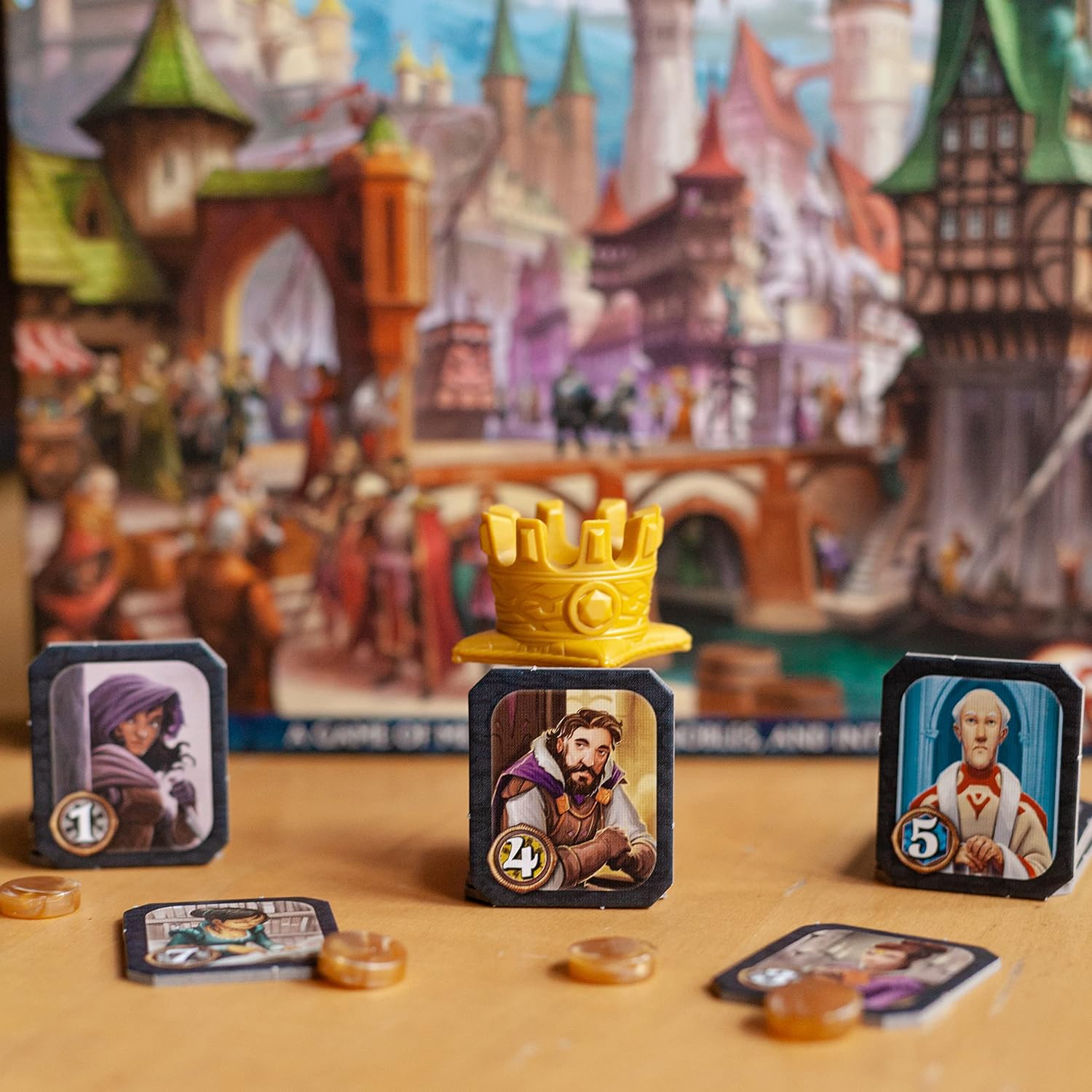 Citadels Revised Edition card game setup with character cards and a crown on a colourful background.