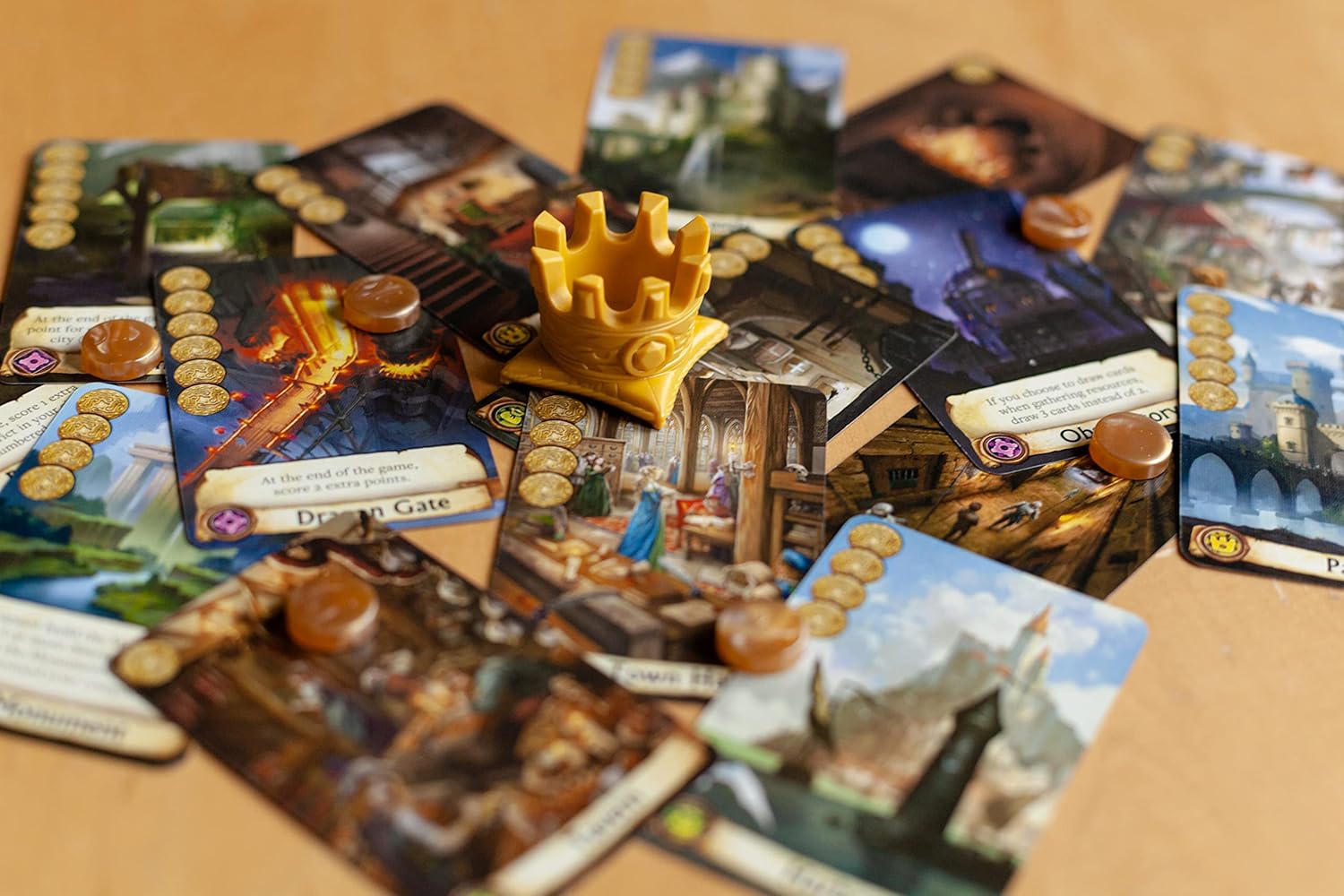 Citadels Revised Edition card game with cards and a castle piece on a wooden surface