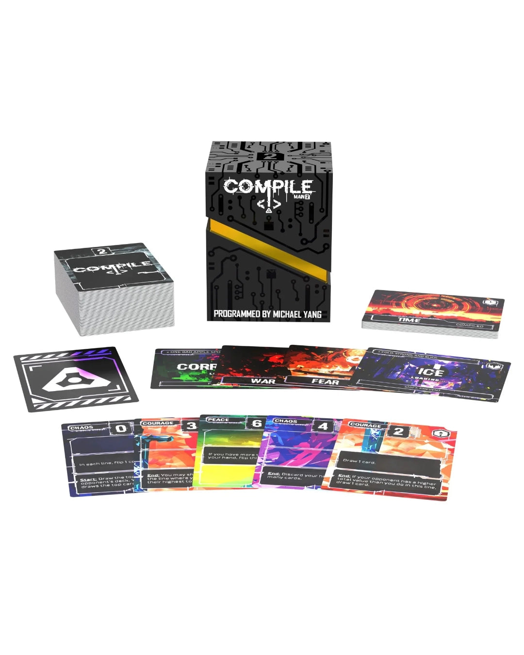 A card game set called 'Complie: Main 2' shown with its black branded box, a silver deck box, a small rulebook, and several colorful game cards arranged on a white background. The box reads 'Compile Main 2' and 'Programmed by Michael Yang.