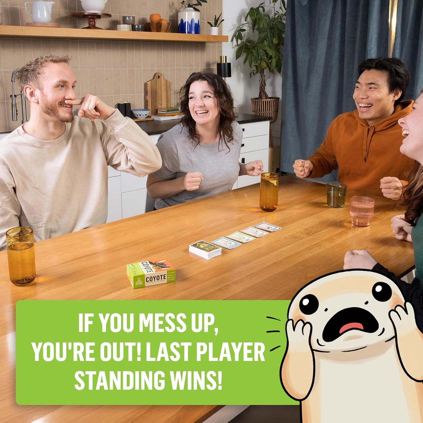 Group of people playing a board game together in a kitchen.