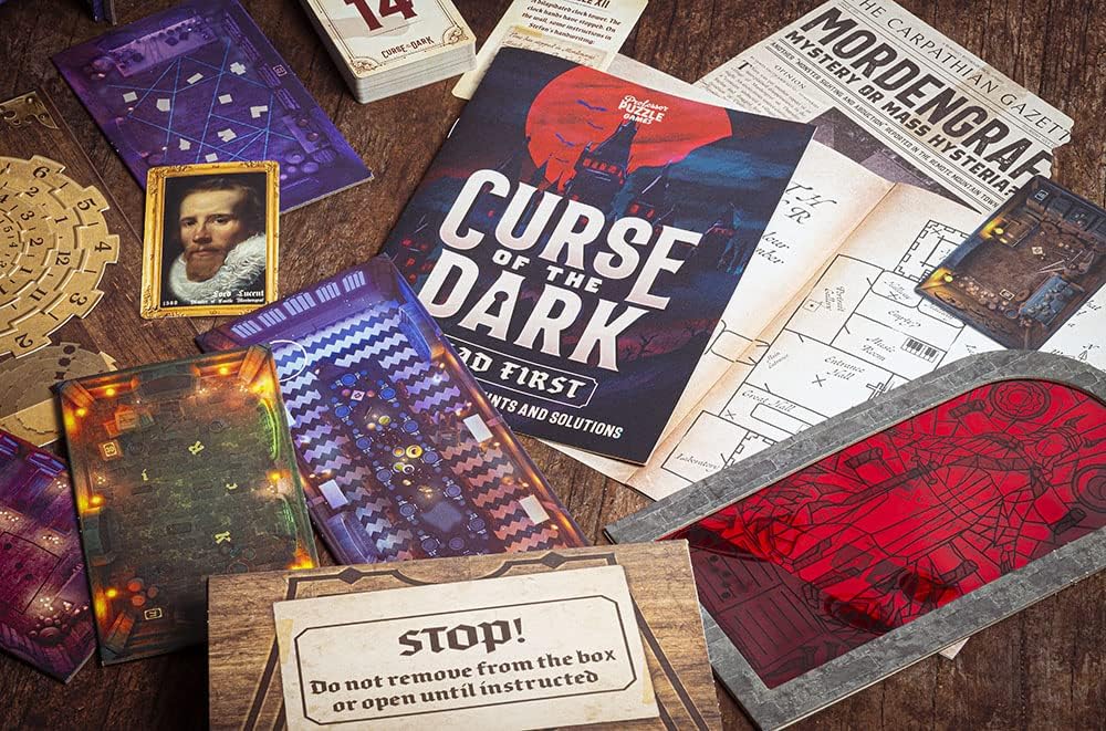 Curse of The Dark Contents laid out on a wooden table