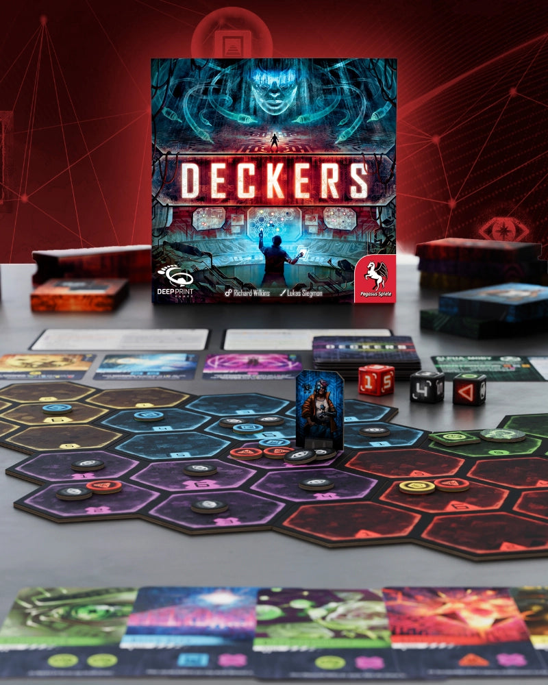 The board game Deckers is displayed with its main box, game board, cards, dice, and tokens on a tabletop. The box features a dark sci-fi illustration with the title 'DECKERS' in large red letters.