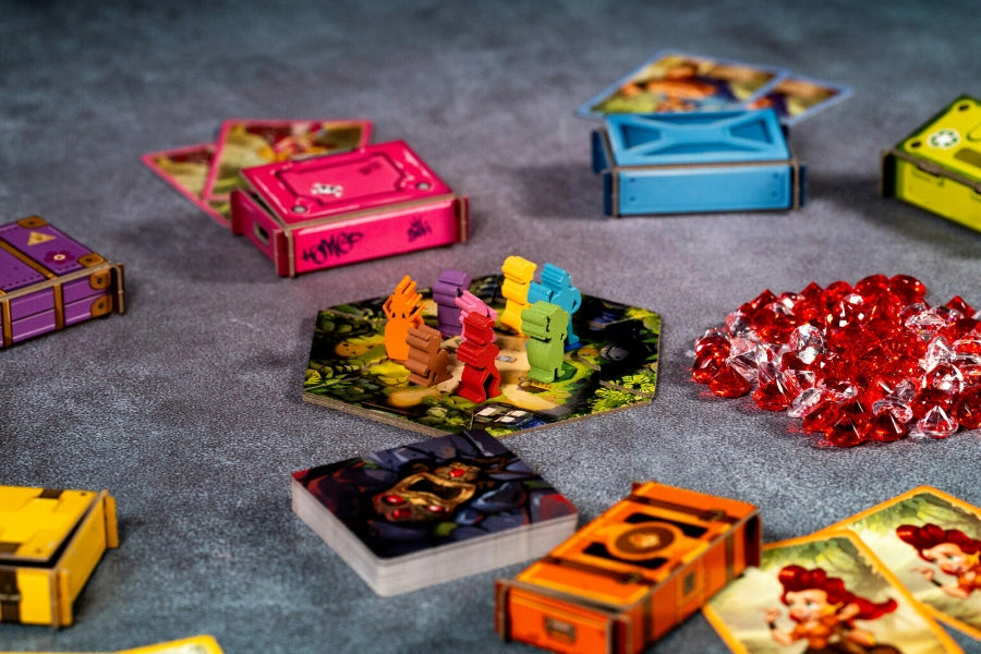 Board game components including cards and dice on a gray surface
