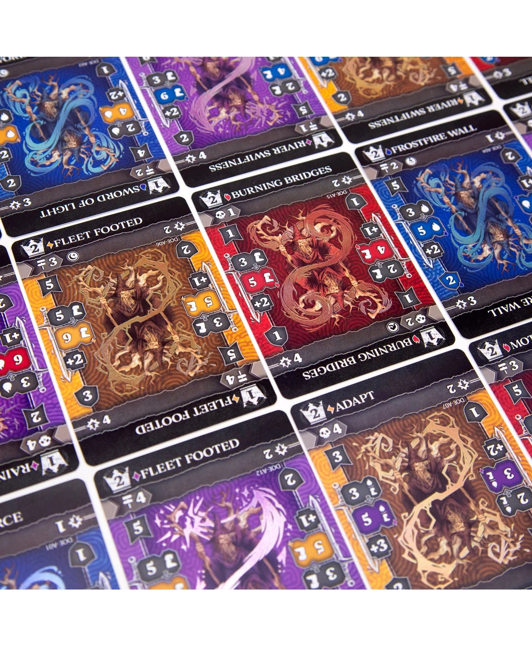 A close-up of a Dragon's of Etchinstone showing multiple fantasy card tiles with illustrated monsters and text such as 'Fleet Footed,' 'Shooting Bridges,' and 'Adapt.'