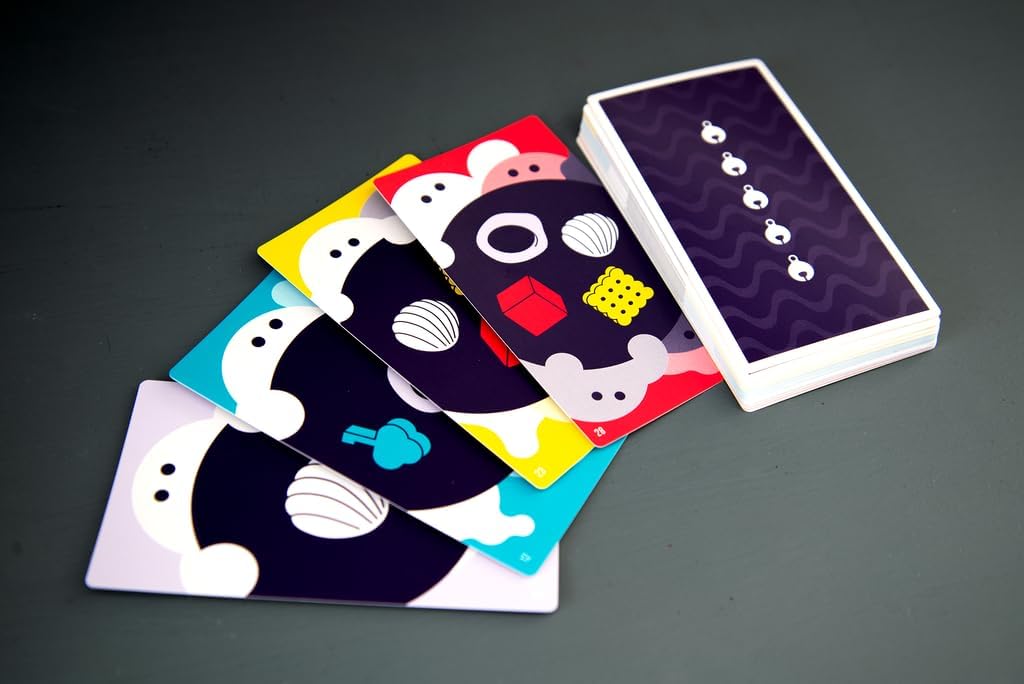 Set of playing cards with colorful face designs on a dark surface
