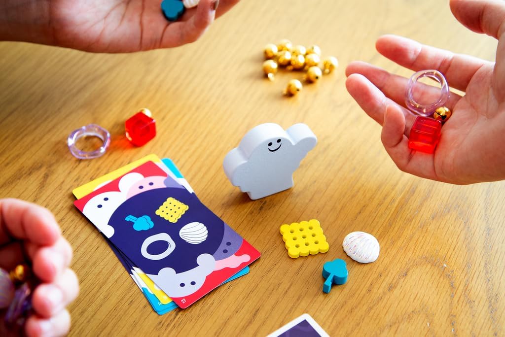 Dro Polter game with cards, toys, and small objects on a wooden table