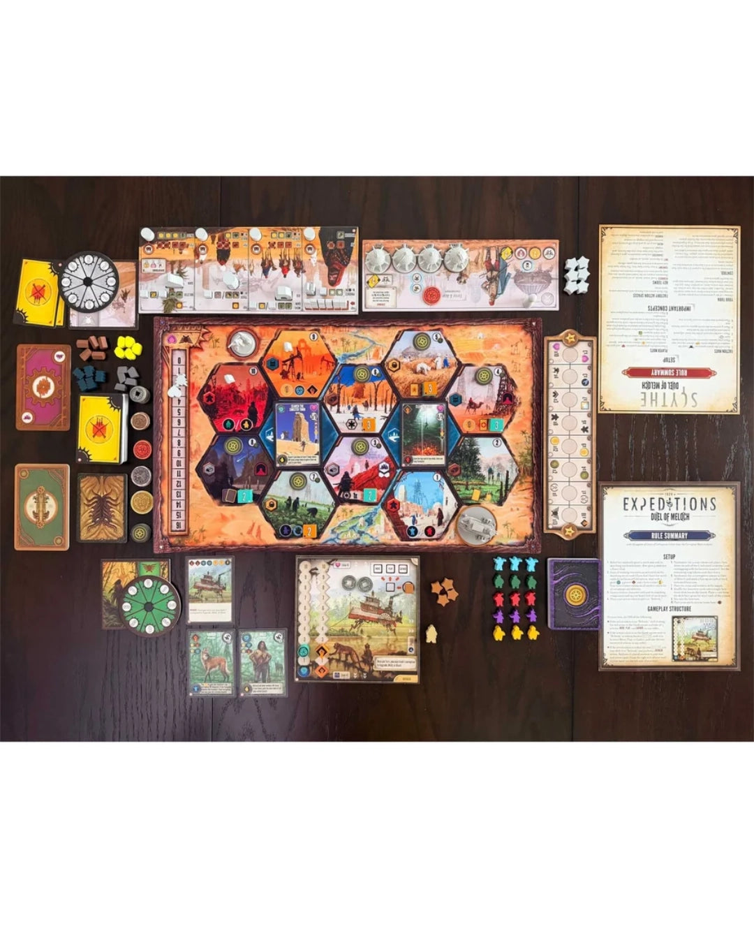 Duel of Meloch: Scythe vs Expeditions arranged on a dark wooden tabletop, including a large central game board, multiple instruction and rule cards, tokens, dice, and small game pieces. No person or animal is present, so this is Product/Packaging rather than Lifestyle.