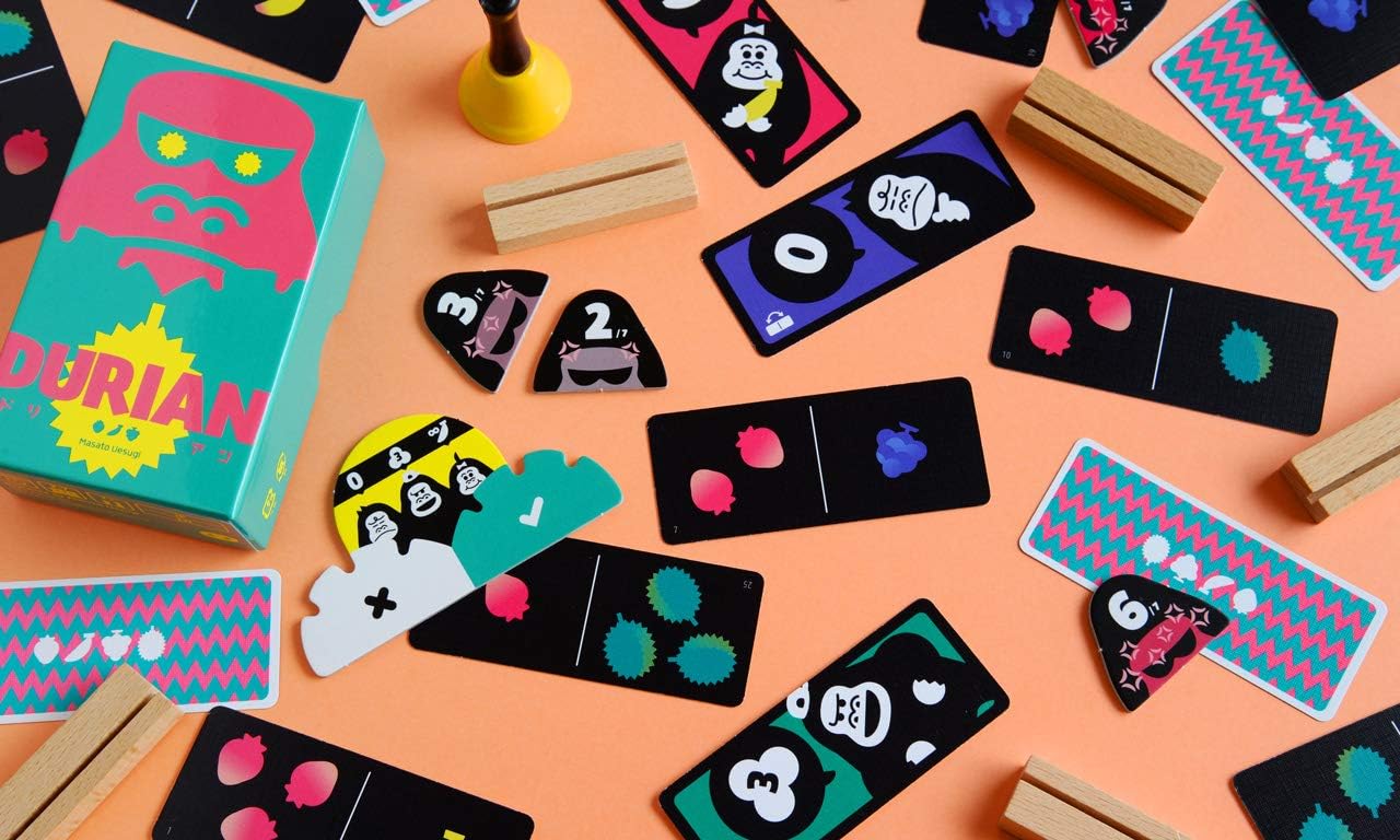 Colourful card game pieces on a peach background