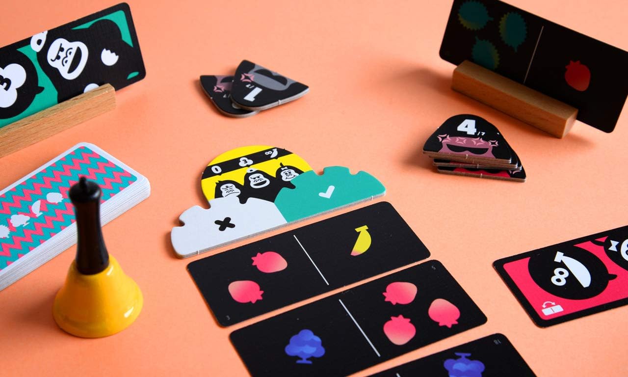 Colourful card game pieces on a peach-colored surface