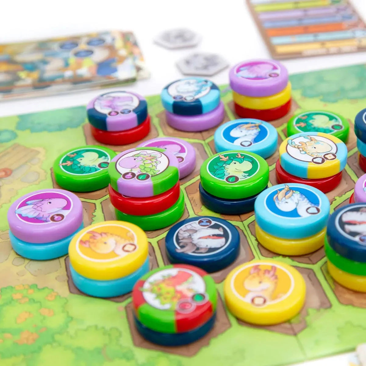 Colourful game pieces for Flamecraft duels on a game board with cartoon characters