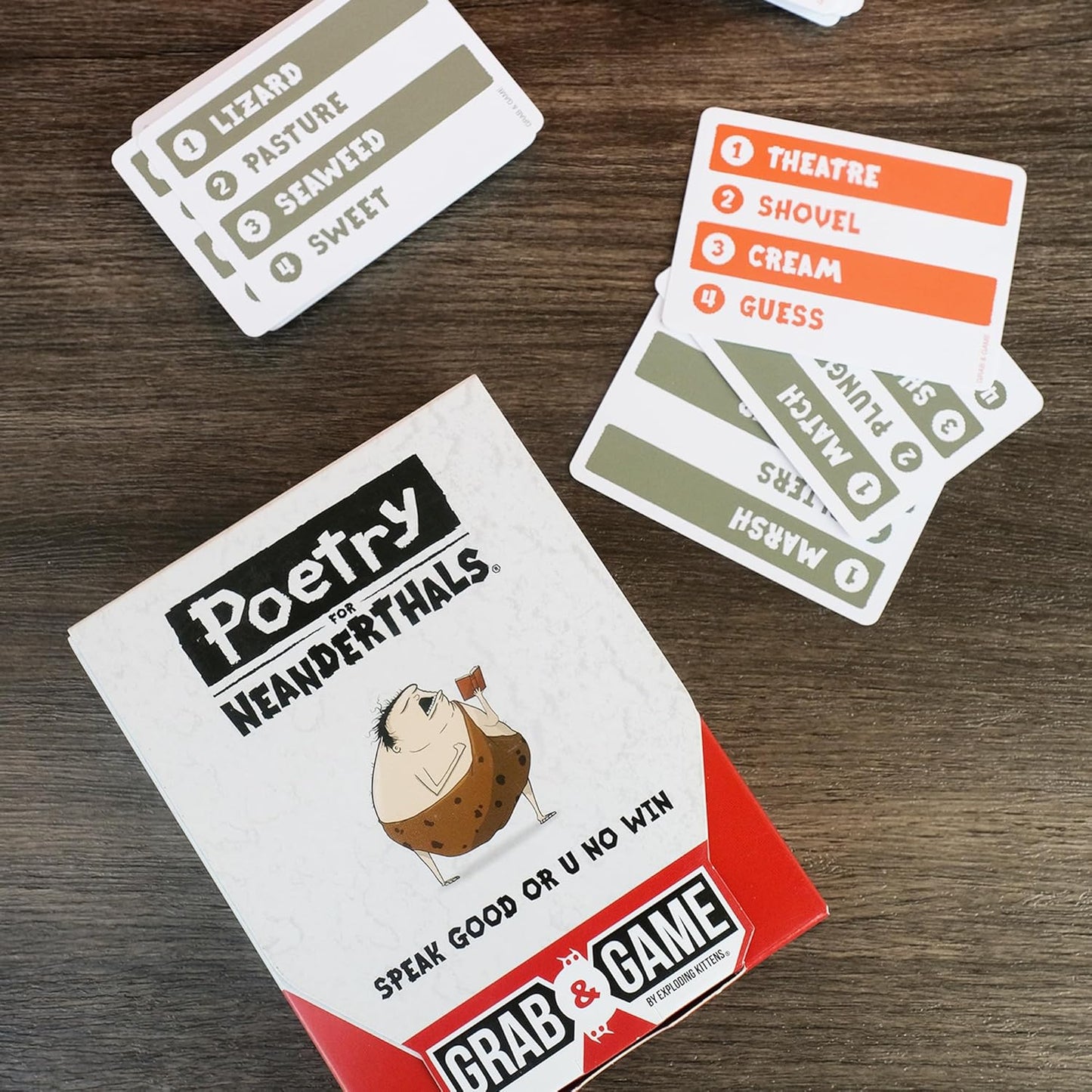 Card game packaging with playing cards on a wooden surface
