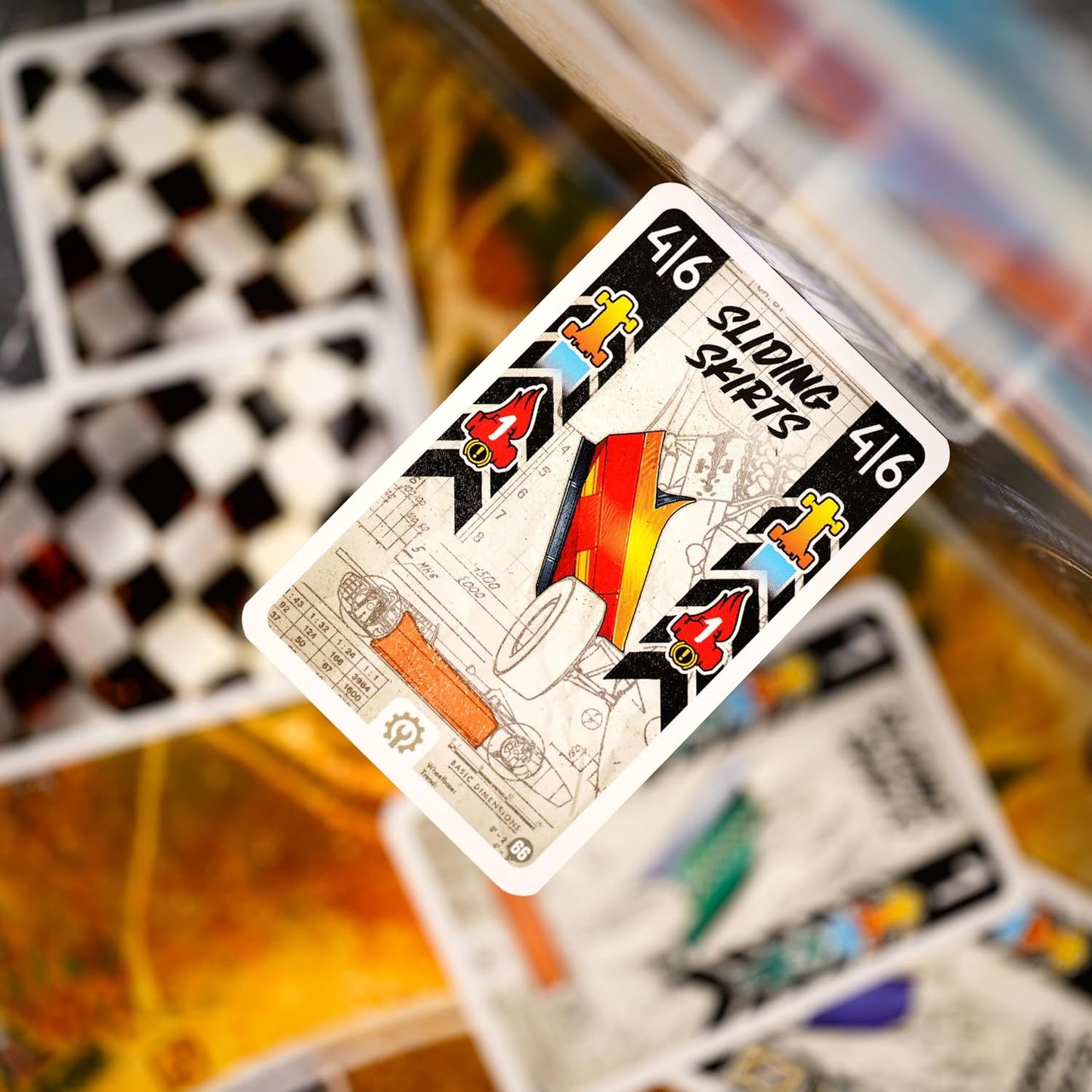 Playing card with colourful design on a blurred background of other cards