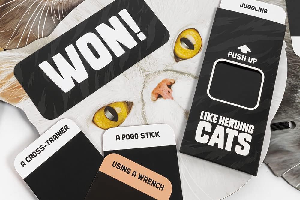 Cardboard game pieces with humorous text and a cat illustration on a white surface.