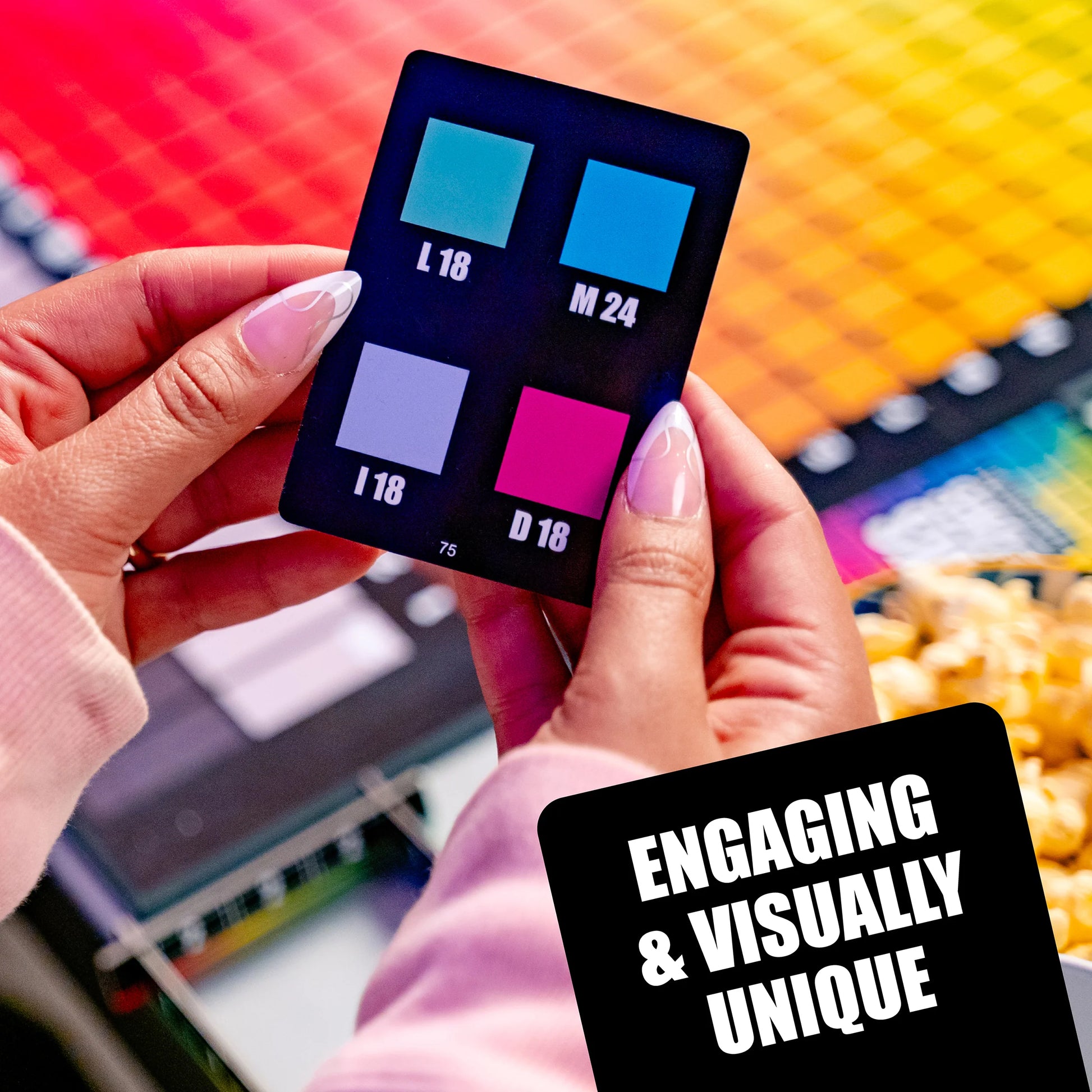 Hues and Cues colourful swatch card held by hands with a colourful background