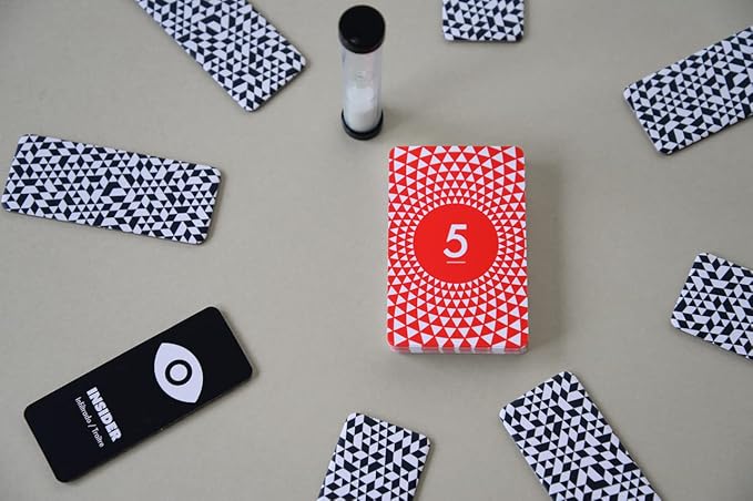 Red card with number 5 surrounded by black and white patterned cards on a gray surface