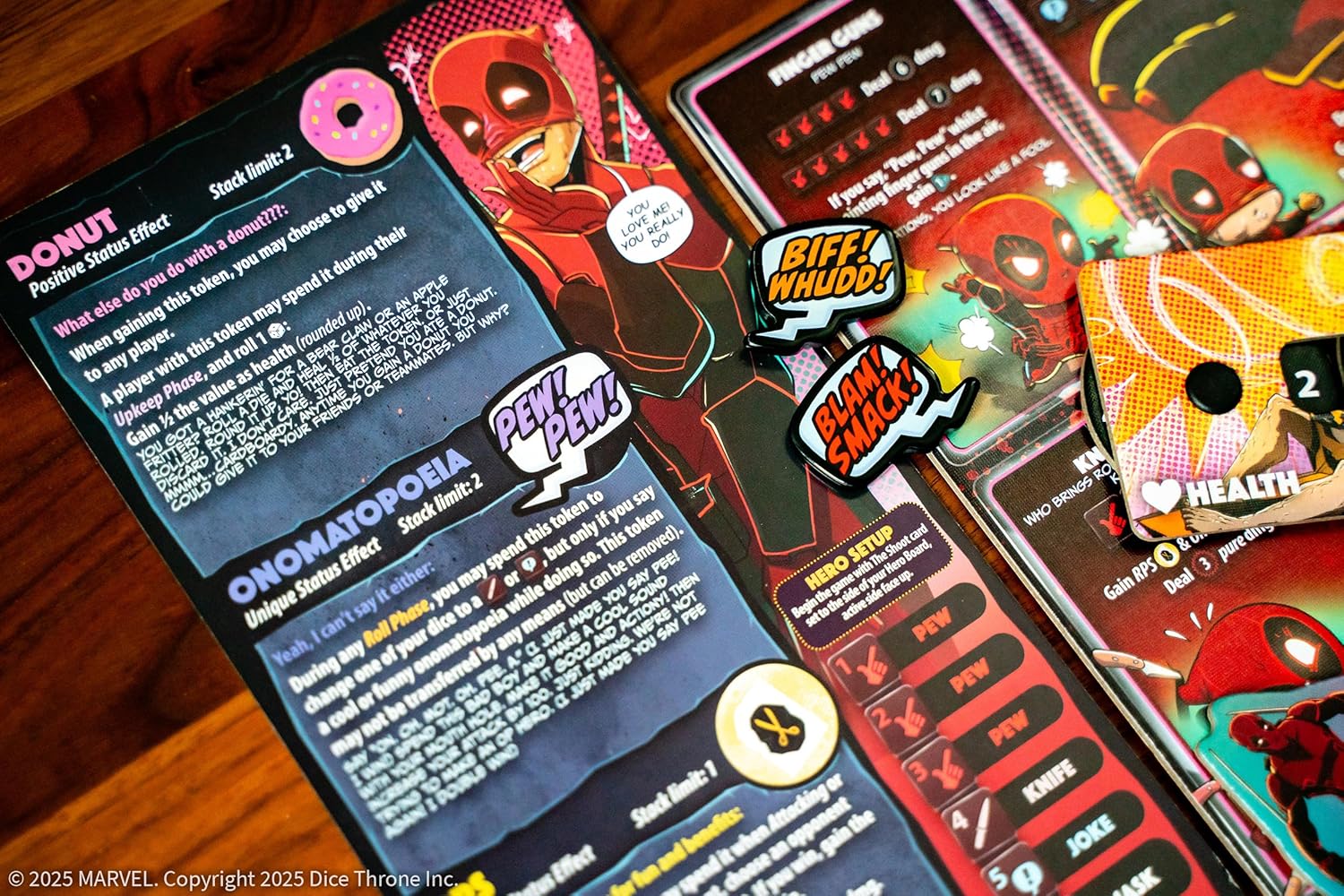 Marvel-themed card game cards with character illustrations and text on a wooden surface.