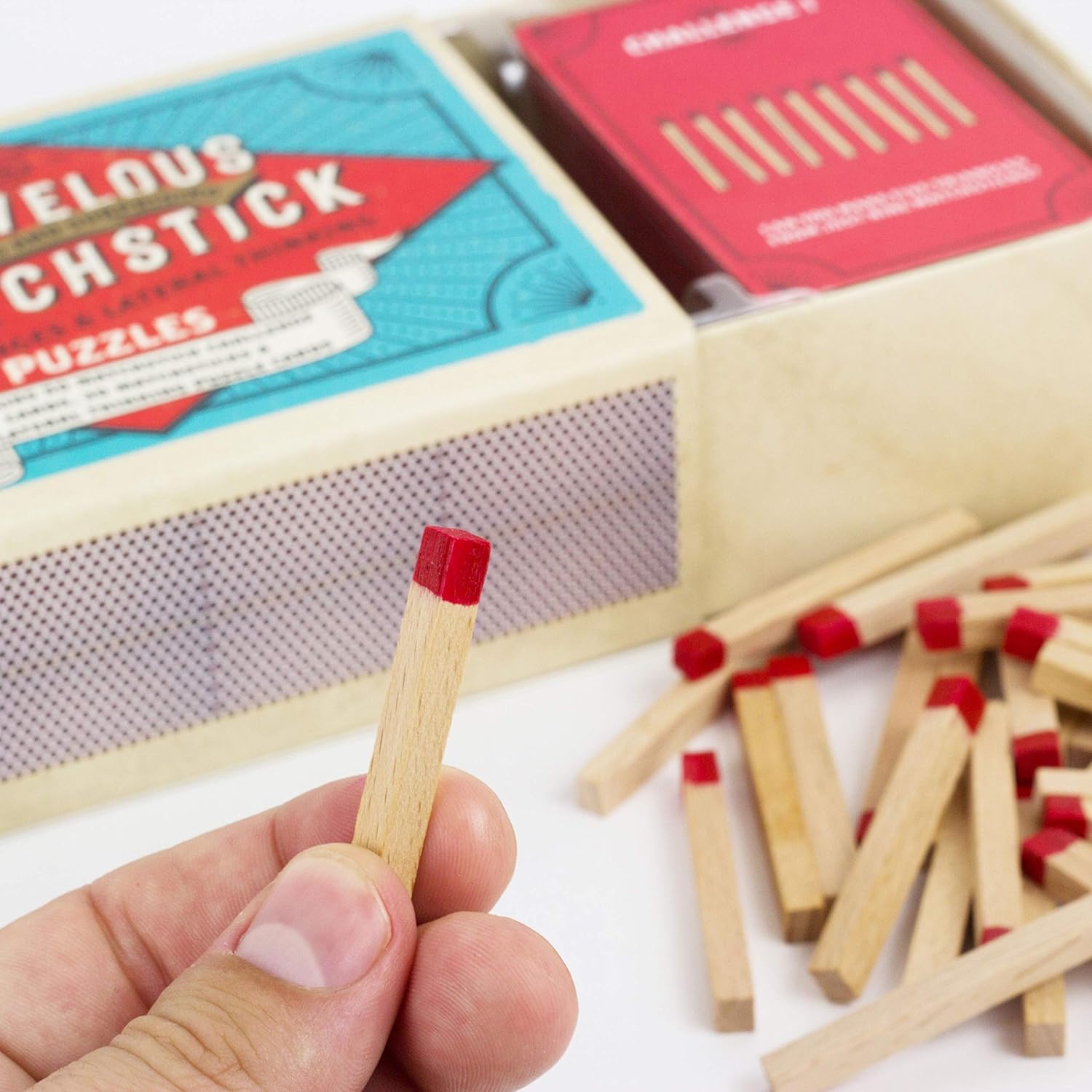 MARIVLOUS MATCHSTICK PUZZLES with hand holding a pretend matchstick