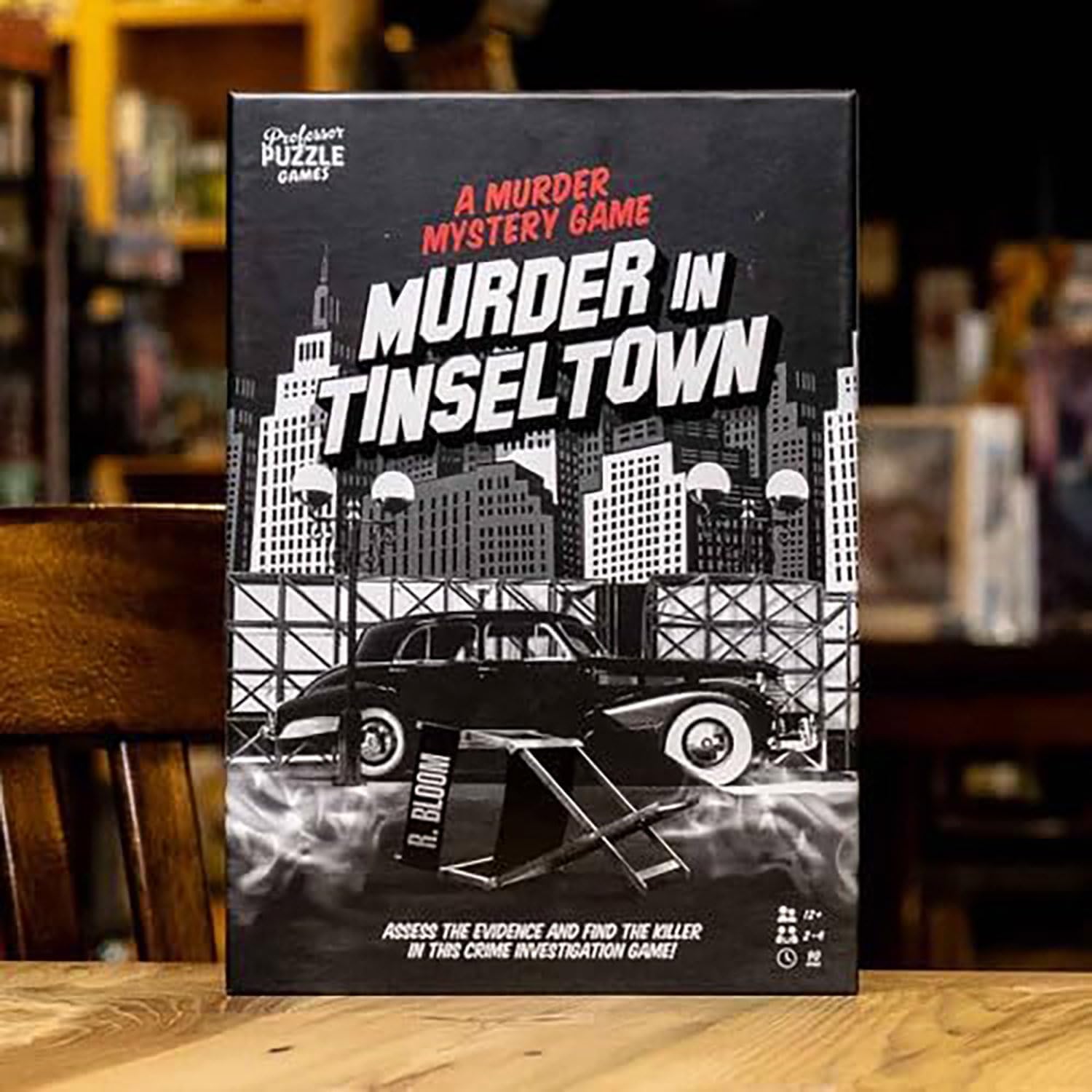 Board game box for 'Murder in Tinseltown' by Professor Puzzle on a wooden surface.