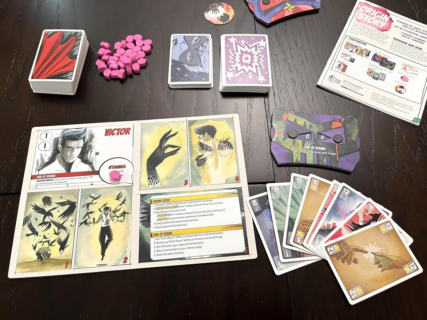 Collection of cards and game pieces on a dark surface