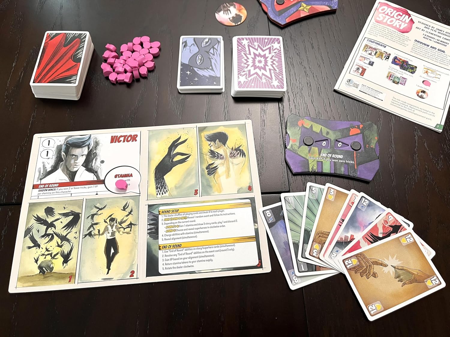 Collection of cards and game pieces on a dark surface