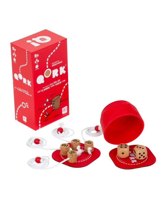 A party game called Qork is set on a white background, featuring a red box, a red cylindrical container opened to reveal wooden dice and small wooden pegs, and several white elastic string pieces with red beads.