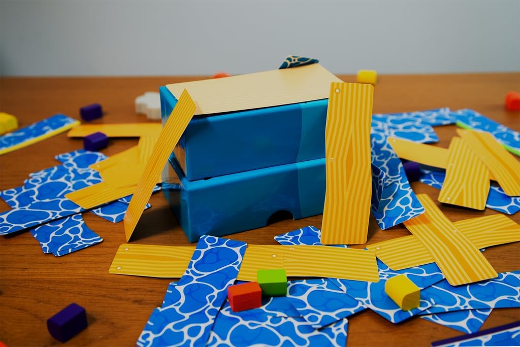 Colourful building blocks on a wooden surface with blue patterned paper
