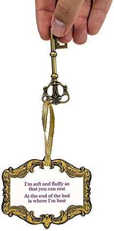 Decorative keychain with ornate frame and text on a white background