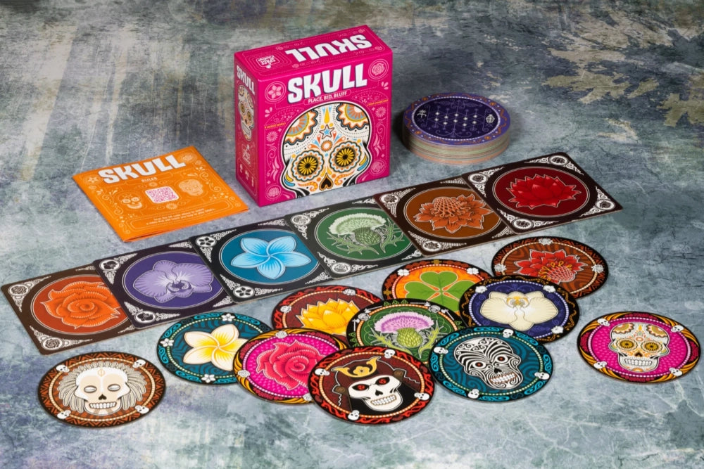 Colorful card game 'Skull' with packaging on a textured surface
