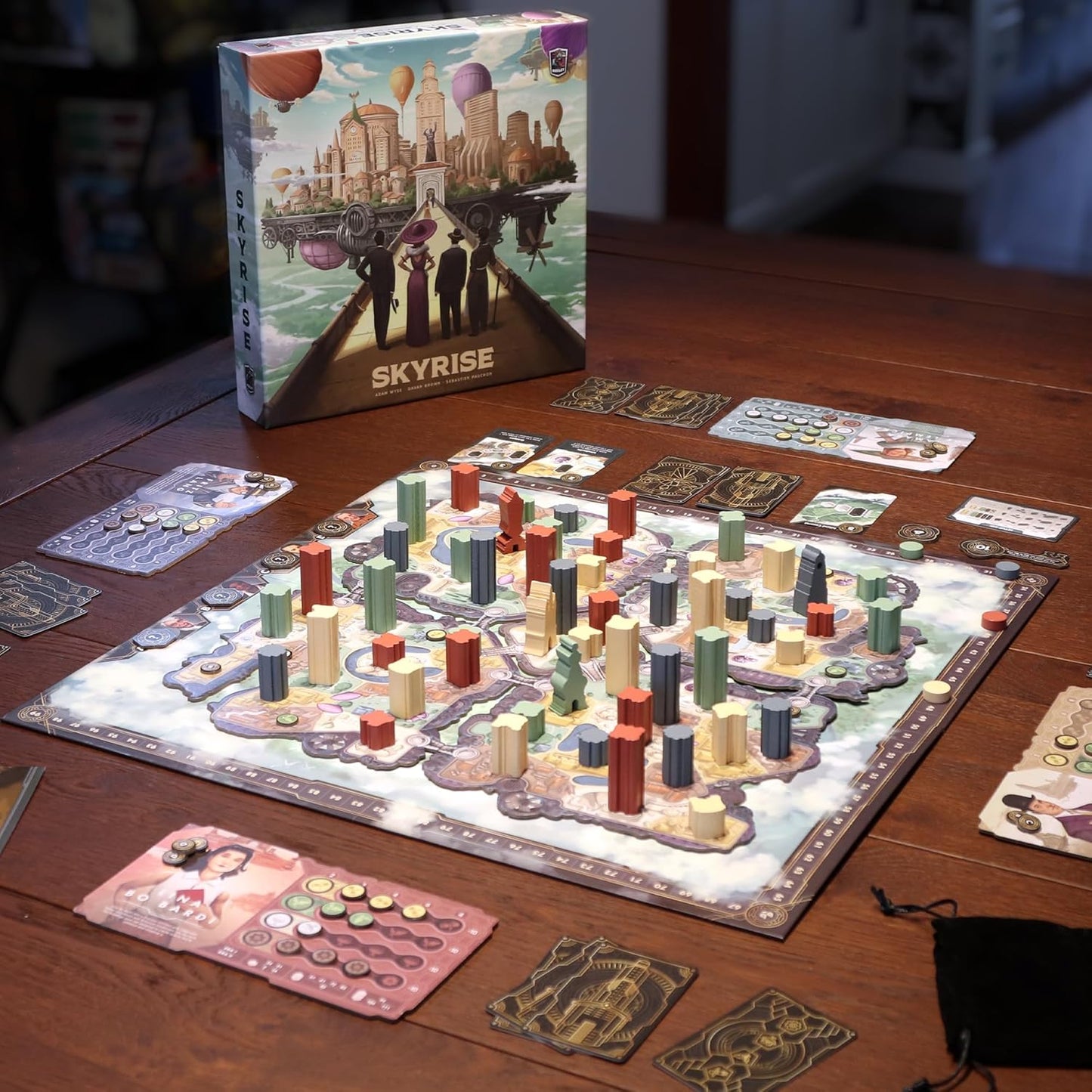 Board game 'Skyrise' with pieces and cards on a wooden table