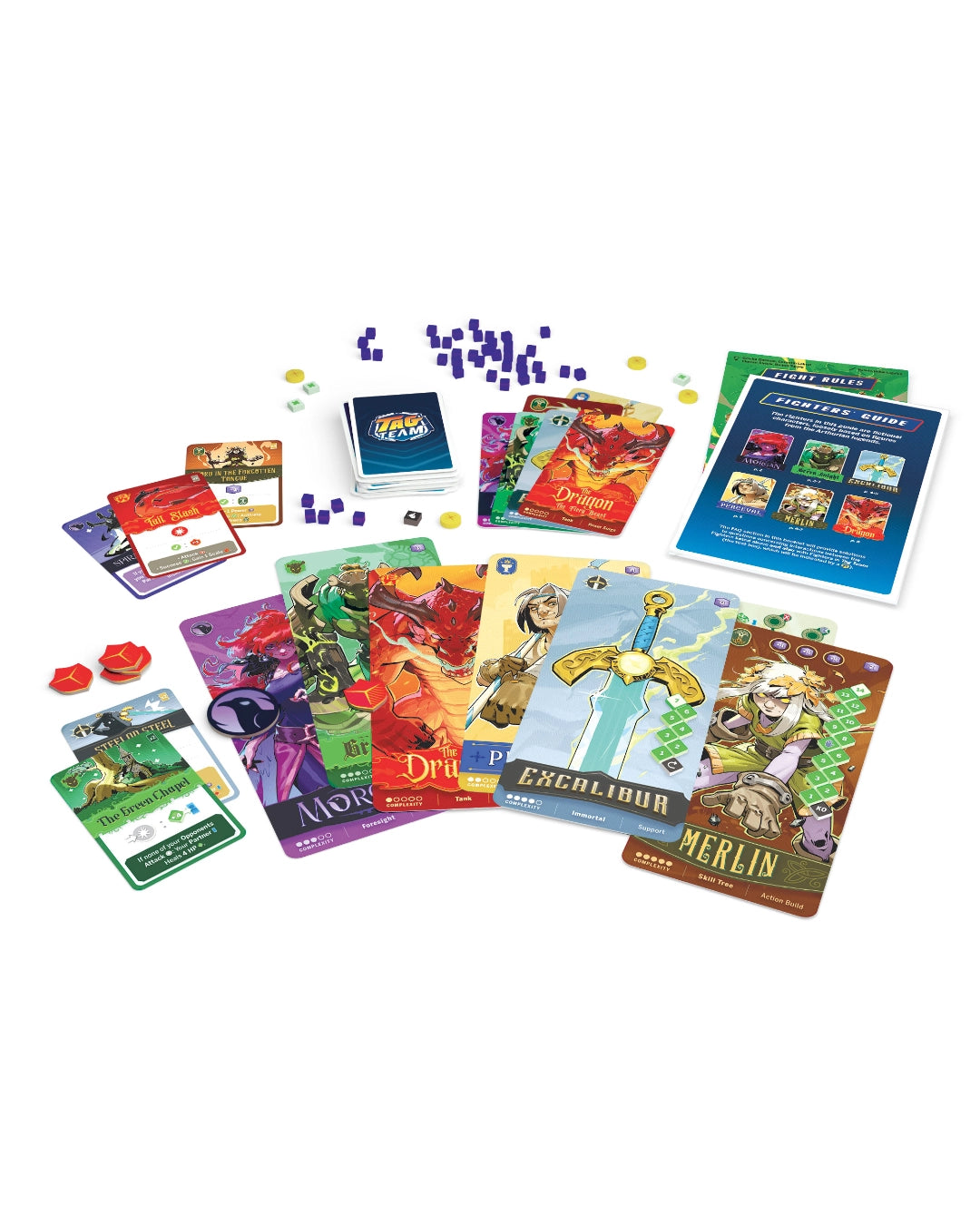 Scorpion Masque 'Tag Team: Arthur's Legacy' card game set with illustrated cards, dice, and a player guide spread out on a plain white background. The cards feature fantasy-themed artwork and text, with visible titles including Merlin, Enchanted Sword, and The Sword of Kings.