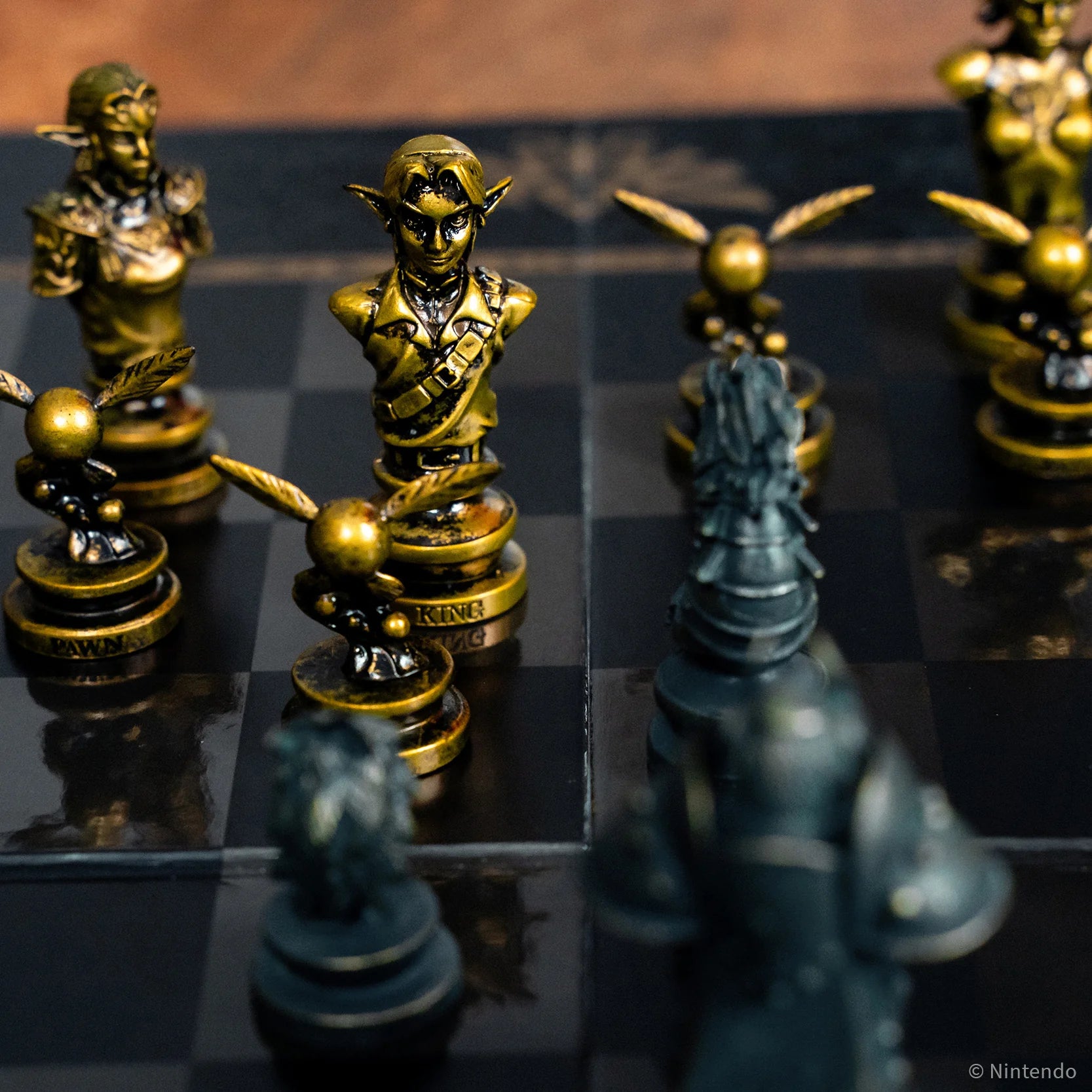 Close-up of The Legend of Zelda chess pieces on a chessboard with a reflective surface.