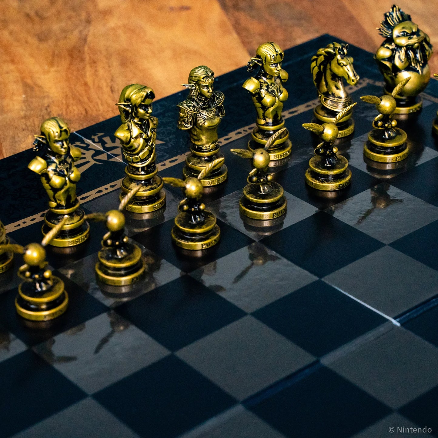 Gold and black The Legend of Zelda chess pieces on a checkered chessboard