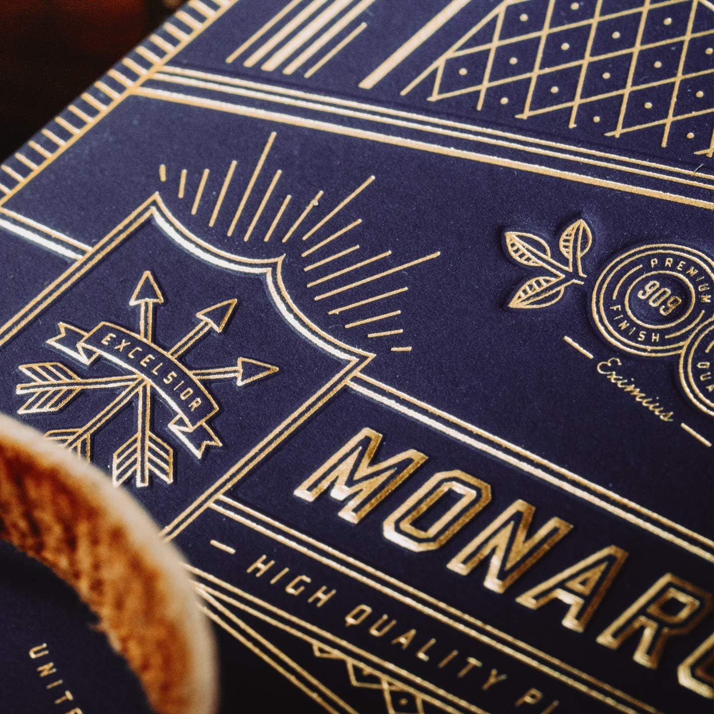 Close-up of a Monarch playing card box with gold text and design elements.