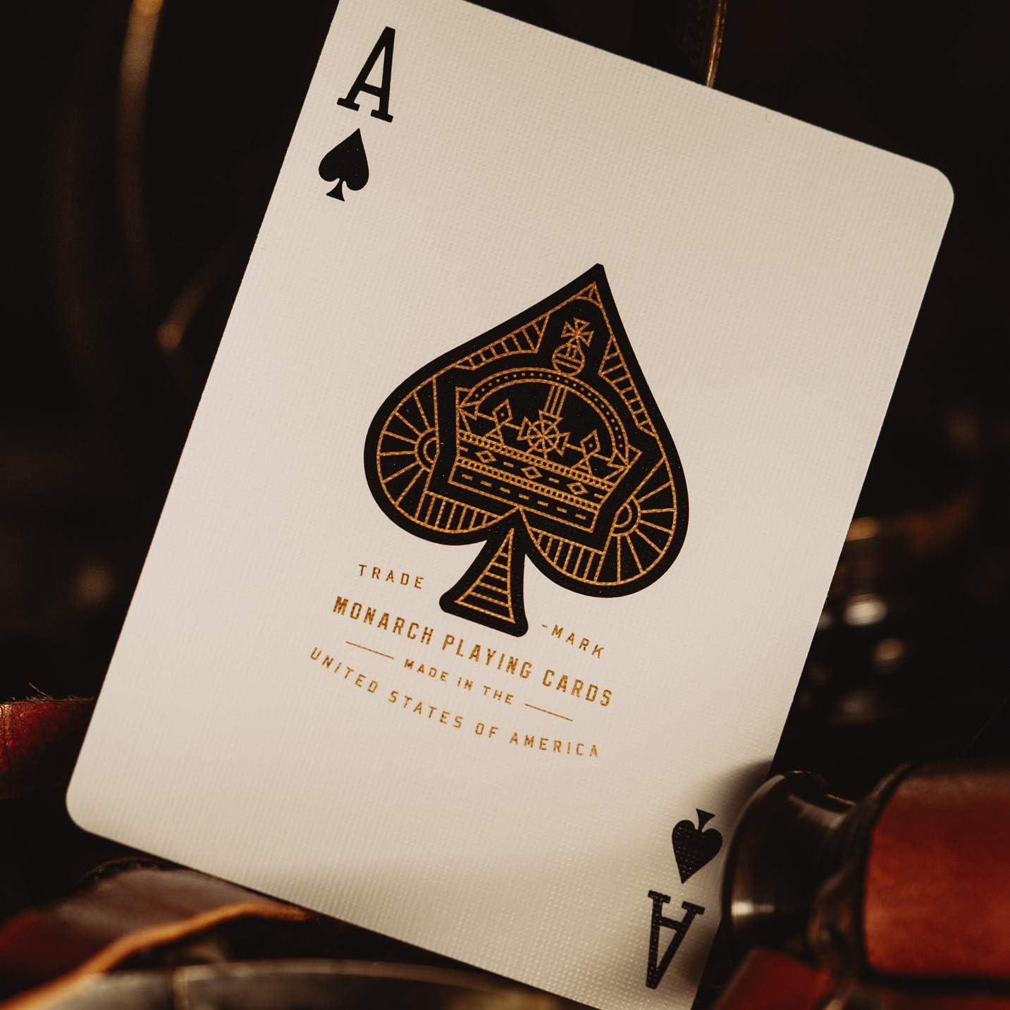 Playing card with spade symbol and text on a dark background