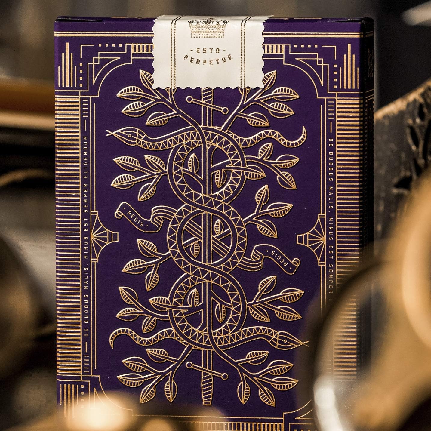 Decorative purple and gold box with intricate designs on a blurred background