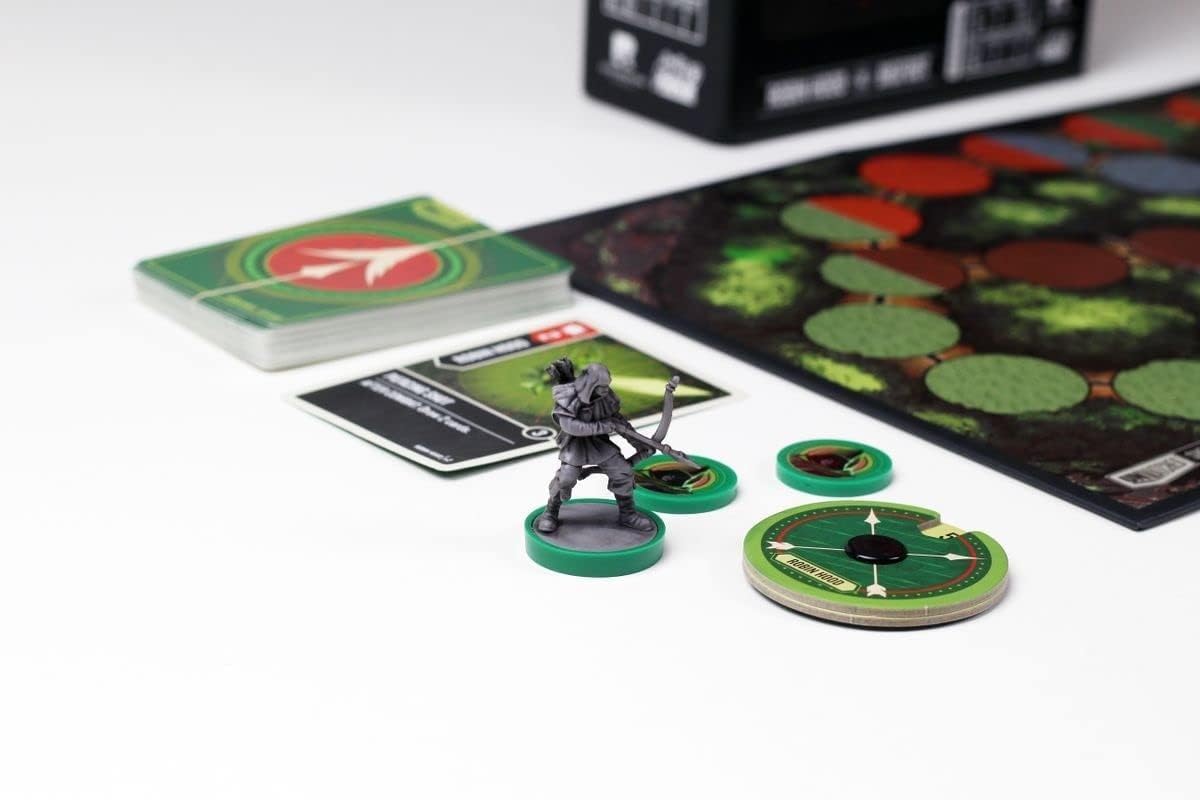 Board game components including cards, a mini figure, and game pieces on a white surface.
