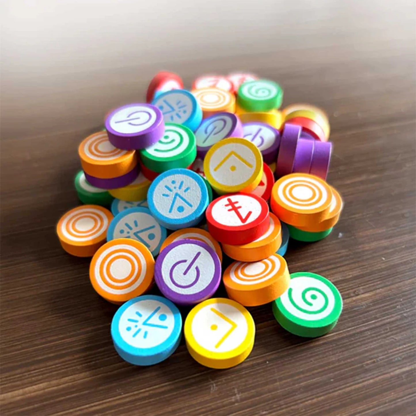 Colourful wooden tokens for Vantage the board game on wooden table